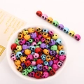 Colorful skull-shaped acrylic beads for DIY jewelry making in a white bowl - 10x12mm Colorful With Black Skull (50pcs)