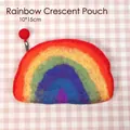 Close-up of rainbow wool felt coin purse measuring 10x15cm with zipper and red pom decoration - Rainbow Crescent Bag