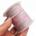 Close-up of tricolor pink and grey braided rope on a spool for DIY jewelry making - Approx. 2.0mm / Pink, Light Gray and White