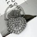 Elegant silver heart-shaped evening bag with shimmering rhinestones and a metal chain strap - Silver Heart Bag with Vertical Triangle Crystals