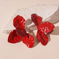 Detailed view of red pleated flower petal earrings on a white textured stone base - Red (Stainless Steel Earring Post)