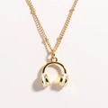 Detail shot of a golden and white enamel headphone pendant on a stainless steel necklace - White Headphones
