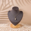 Swan pendant necklace with white pearl and gold chain on gray display stand - Small / Gray