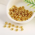 Polished 18K gold plated wheel-shaped spacer beads in a white ceramic bowl for DIY jewelry - 6mm Hole 2.0mm / 18K Gold
