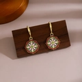 Detail shot of vintage floral mandala earrings with long tassels on a wooden display stand - Vintage Mandala Floral (E635)