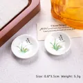 Miniature blue and white porcelain plate with green leaf motif and Chinese calligraphy - Orchid