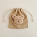 Macro detail of corduroy texture and plush bear ornament on drawstring storage pouch - Apricot (Milk Tea Bear)
