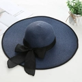 Detail of navy straw sun hat with wide brim and large black silk bow decoration - M (56-58cm) / Navy Blue
