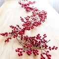 Lush artificial red berry garland for Christmas home decor on a wooden surface - Red Berry Garland