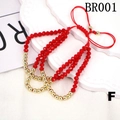 Detail of red faceted beads bracelet with gold spacers and adjustable woven cord - One Size / Red
