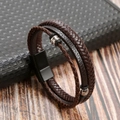 Macro shot of dark brown multi-layer braided leather bracelet with silver metal beads - Coffee