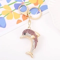 Detailed macro view of a golden dolphin keychain with purple and clear rhinestones - Dolphin 3 (Purple)