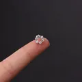 Mini stainless steel flower tragus stud with white zircon crystals on a fingertip - Six-Petal Diamond Flower Shape (HSPJ356-8#)