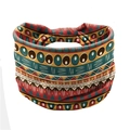 Elastic yoga headband featuring a colorful ethnic geometric pattern on a white background - Orange