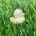 Green aventurine crystal duck figurine handcrafted with natural stone on grass - Afghan Jade