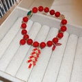 Handwoven red festive bracelet with gold firecracker charm and green gemstone accent - Festive Firecracker Style (3# Bracelet-Red)