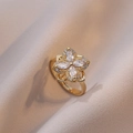 Elegant gold clover open ring with marquise-cut zircon petals on beige satin fabric - Ring / Gold