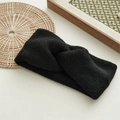 Detail of twisted black knit headband with soft texture on a minimalist background - Black