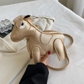 Creative golden horse-shaped leather shoulder bag held by hand for a stylish look - Gold