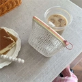 White mesh organizer bag with pink and yellow contrast zipper in a cafe setting - White + Yellow Pink Zipper