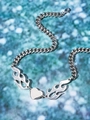 Detail shot of a silver heart pendant with flame pattern and chunky curb chain on blue glitter - Silver Heart Flame Pendant with Tank Chain