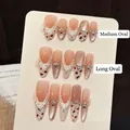 Uñas postizas hechas a mano con perlas ojo de gato, encaje blanco y detalles florales rojos - Ovalado Largo (662) / XS