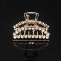 Detailed view of 5cm golden hair claw clip with pearls on black reflective surface - Full Pearl Mini Crescent 5CM Claw Clip