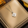 Elegant silver clover necklace with white shell and crystals on a gold jewelry box - 8802 Steel White