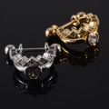 Gold and silver crown stud earrings with heart zirconia on a black reflective background - NO 16