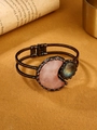 Detail of vintage bronze moon bracelet with rose quartz and labradorite on warm velvet - Rose Quartz