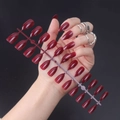 Detail of glossy deep red pointed almond press-on nails with shiny UV top coat - Glossy Dark Red (JJL-25)