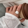Silver oval ring with brushed texture on female hand holding a coffee cup - Silver Oval Brushed Texture Ring (J6997)