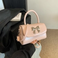 Pink bow handbag in glossy patent leather with a silver butterfly buckle for women - Pink