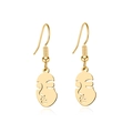 Detailed close-up of golden hollow abstract face earrings with sleek metallic finish - Gold