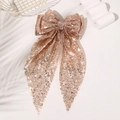 Detail of rose gold oversized hair bow with shiny sequins and long streaming ribbons - Champagne