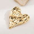 Golden heart-shaped metal jewelry tray with a unique hammered texture and glossy finish - Heart Gold