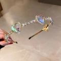 Detail view of gold headband featuring emerald heart crystals and sparkling cubic zirconia - Gold Heart Style (FG0009-18)