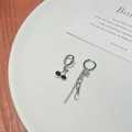 Detail shot of asymmetric cherry drop earring and chain link on white ceramic tray - Asymmetric Cherry Earrings