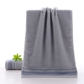 Plush grey cotton face towel featuring classic navy blue striped jacquard border detail - Staggered Stripe Grey / 34*74cm