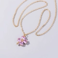 Detail of pink heart-shaped crystal clover pendant on a fine golden necklace chain - Pink Heart Clover Necklace (SE1116)