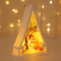 Detail of a white Christmas lantern featuring a snowman scene and warm LED lights - Snowman