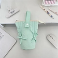 Close-up of mint green quilted stationery bag with bow detail and zipper closure - Fresh Green