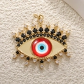 Macro detail of Evil Eye charm with blue crystals and gold plating on stone - A0248