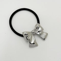 Elastic black hair tie featuring a polished silver alloy bow pendant on white background - Squared Silver