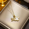 Gold titanium clover necklace with white shell and clear gemstone on jewelry box - 8922 White Clover