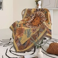 Detail of bohemian sun and flower woven throw blanket with fringes on rattan chair - Ginger Yellow / 130x160cm