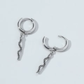 Detailed macro view of silver snake dangle earrings in trendy titanium steel metal - Snake Style