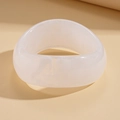 Close-up of translucent white acrylic bangle with cloudy marble texture and geometric design - Clear White