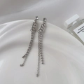 Elegant long silver tassel earrings with zircon inlay and chain detail on white tray - Long Bead Chain Tassel