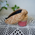 Close-up of a knotted raffia headband with woven texture on a white lace cloth - Brown-Yellow Series Knotted